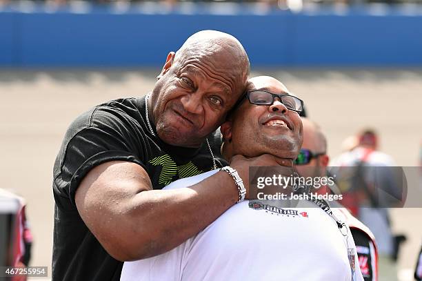 Tommy 'Tiny' Lister poses for photos with fans prior to the start of the NASCAR Sprint Cup Series Auto Club 400 at Auto Club Speedway on March 22,...