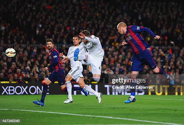 Jeremy Mathieu of Barcelona scores their first goal with a header during the La Liga match between FC Barcelona and Real Madrid CF at Camp Nou on...