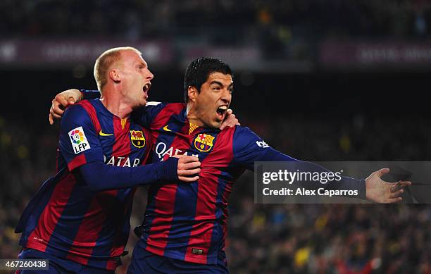 Jeremy Mathieu of Barcelona celebrates with Luis Suarez as he scores their first goal with a header during the La Liga match between FC Barcelona and...