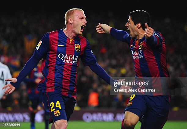 Jeremy Mathieu of Barcelona celebrates with Luis Suarez as he scores their first goal with a header during the La Liga match between FC Barcelona and...