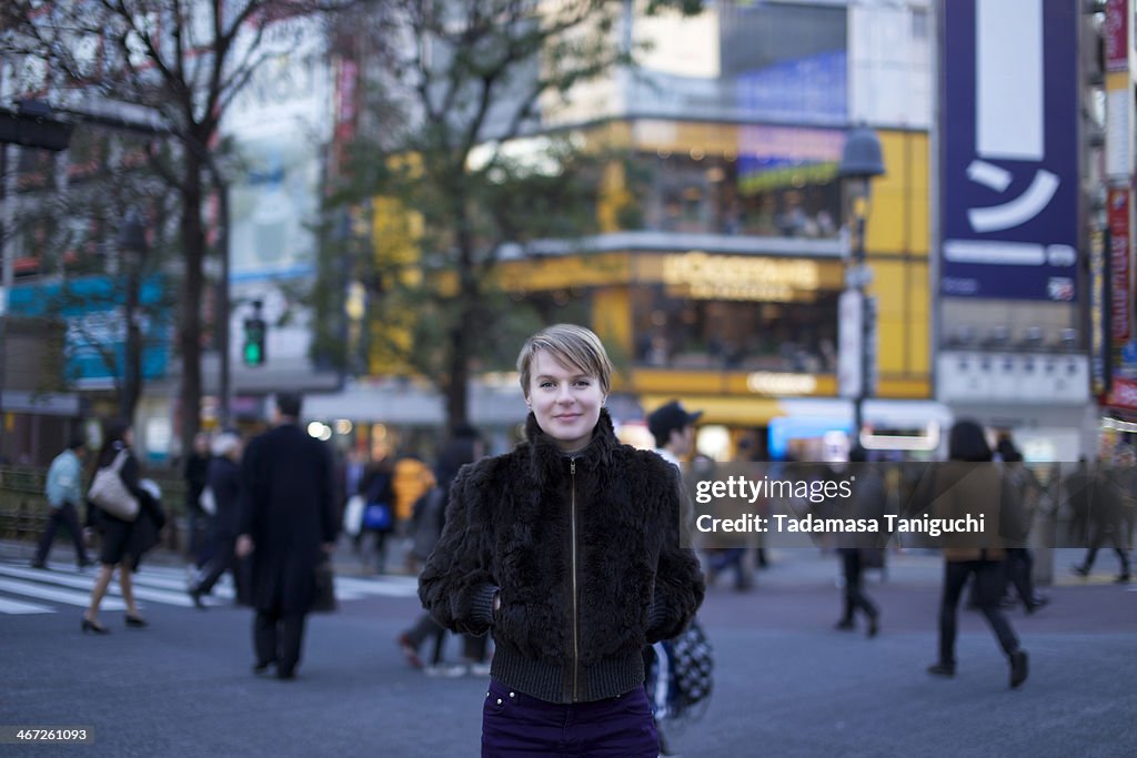 Woman smiling on a street intersection