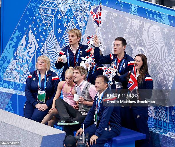 Stacey Kemp and David King of Great Britain wait with teammates for their score after competing in the Figure Skating Pairs Short Program during the...