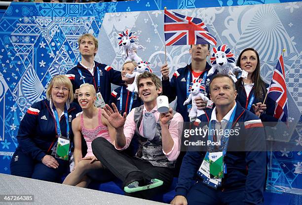 Stacey Kemp and David King of Great Britain wait with teammates for their score after competing in the Figure Skating Pairs Short Program during the...