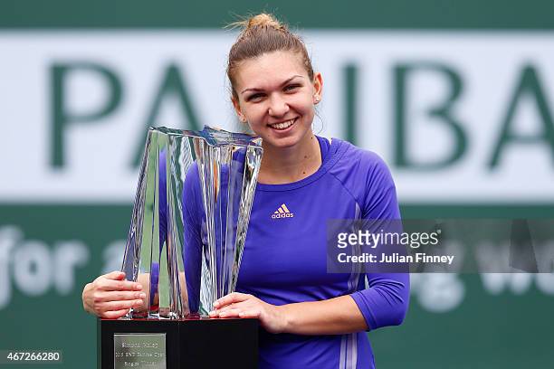 Simona Halep of Romania with the winners trophy after defeating Jelena Jankovic of Serbia in the final during day fourteen of the BNP Paribas Open...