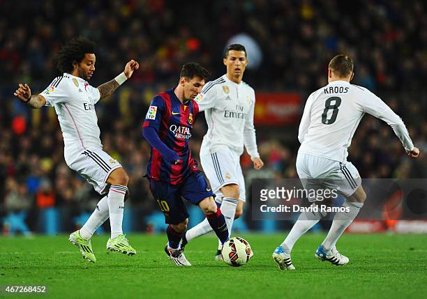 Lionel Messi of Barcelona takes on Marcelo , Cristiano Ronaldo and Toni Kroos of Real Madrid CF during the La Liga match between FC Barcelona and...