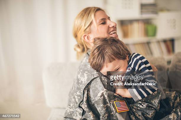 safe in mommy soldier's hug - armed forces stock pictures, royalty-free photos & images