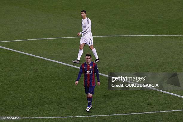 Barcelona's Argentinian forward Lionel Messi and Real Madrid's Portuguese forward Cristiano Ronaldo walk on the field during the "clasico" Spanish...
