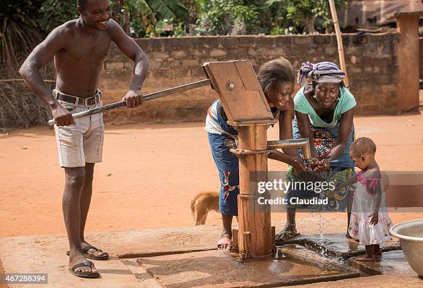 african family at a well - water well stock pictures, royalty-free photos & images