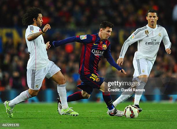 Lionel Messi of Barcelona goes between Marcelo and Cristiano Ronaldo of Real Madrid CF during the La Liga match between FC Barcelona and Real Madrid...