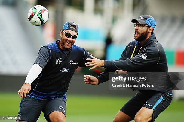 New Zealand batting coach Craig McMillan warms up with Daniel Vettori of New Zealand during a New Zealand nets session at Eden Park on March 23, 2015...