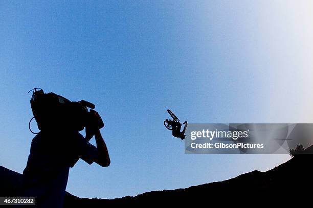 mountain bike cameraman - stunt stock pictures, royalty-free photos & images