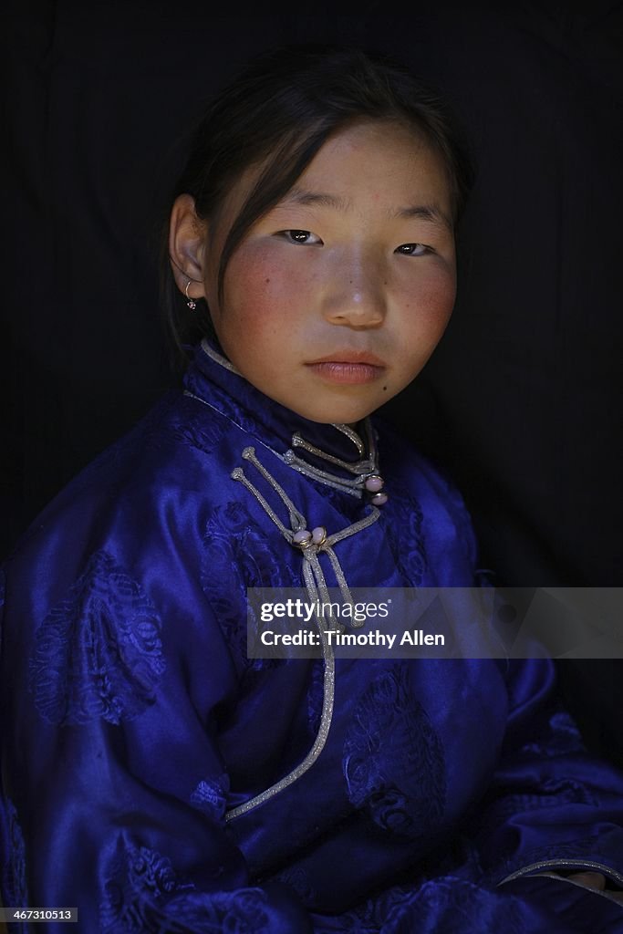 Mongolian girl wearing traditional blue deel dress