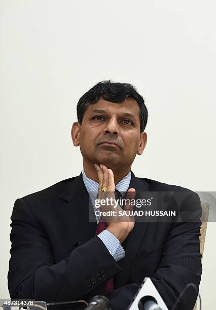 Reserve Bank of India governor, Raghuram Rajan gestures during a joint press conference with Indian finance minister Arun Jaitley after a meeting...