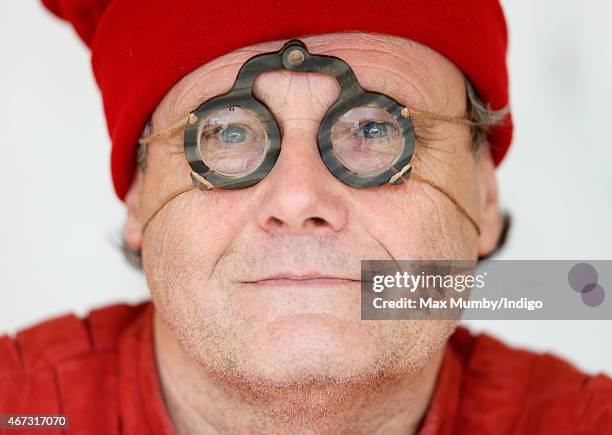 Member of a re-enactment group dressed as a spectacle maker of the 1480's awaits the arrival of the coffin containing the remains of King Richard III...