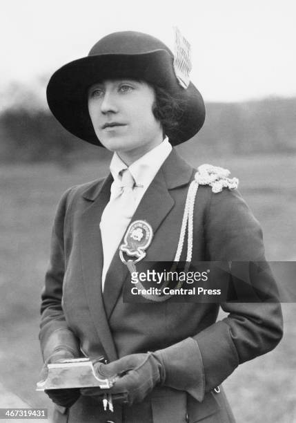 Lady Elizabeth Bowes-Lyon receives a gift from the 1st Glamis Company of Girl Guides, circa 1923. The Company was formed in 1922, with Lady Elizabeth...