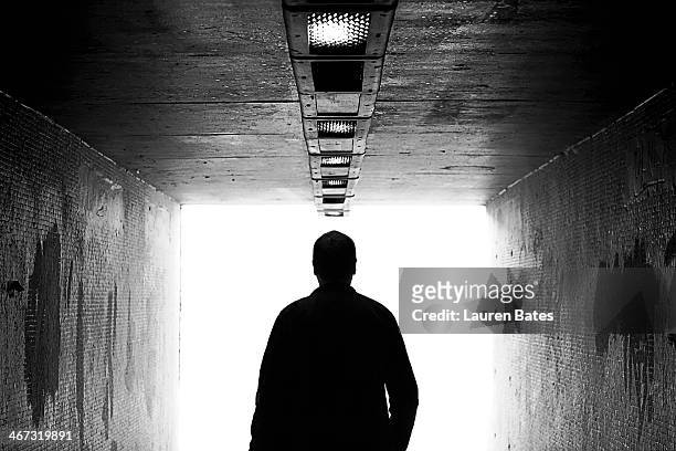 towards the light - male silhouette stock pictures, royalty-free photos & images
