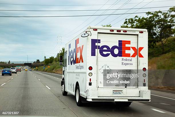 fedex truck on a freeway in sacramento - federal express stock pictures, royalty-free photos & images