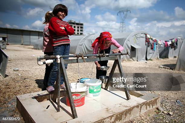 Woman collects water in a refugee camp on March 22, 2015 in Suruc, in the province of Sanliurfa, Turkey. Turkey has one of the largest populations of...