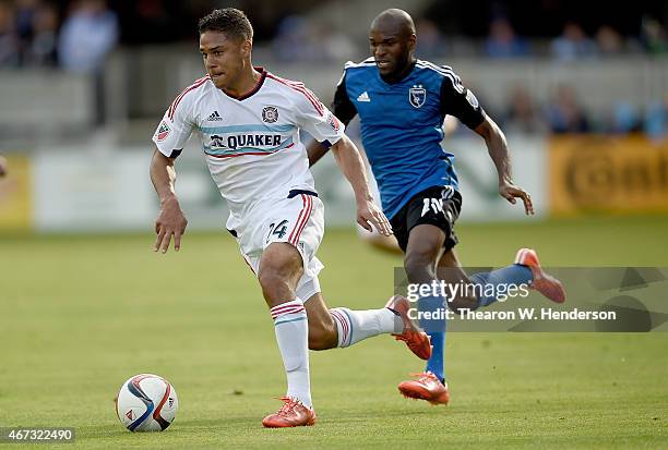 Quincy Amarikwa of Chicago Fire dribbles the ball towards the goal pursued by Innocent Emeghara of San Jose Earthquakes during the first half at...