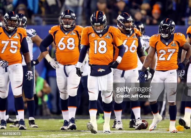 Quarterback Peyton Manning of the Denver Broncos reacts alongside teammates tackle Chris Clark, guard Zane Beadles, center Manny Ramirez and running...