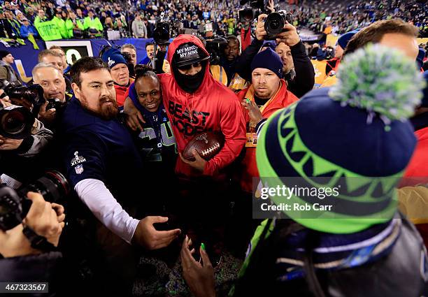 Running back Marshawn Lynch of the Seattle Seahawks celebrates with his mother Delisa Lynch after their 43-8 victory over the Denver Broncos during...