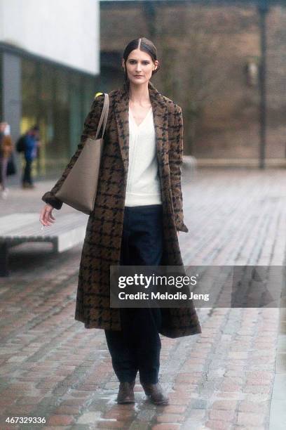 French model Marie Piovesan exits the Paul Smith in a Haider Hackermann coat and Celine pants during London Fashion Week Fall/Winter 2015/16 at...