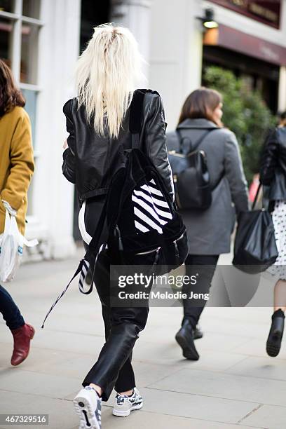 Model Aly Turska wears Zara, Adidas sneakers, Off White backpack, and Mo&Co white cardigan during London Fashion Week Fall/Winter 2015/16 at Somerset...