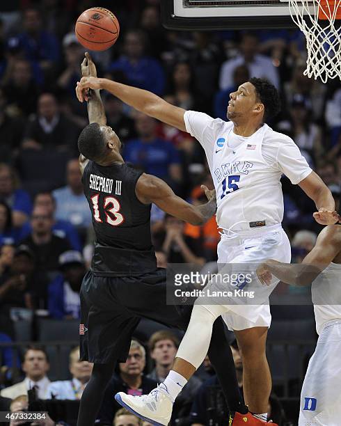 Jahlil Okafor of the Duke Blue Devils defends a shot by Winston Shepard of the San Diego State Aztecs during the third round of the 2015 NCAA Men's...