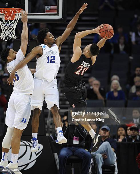 Jahlil Okafor and Justise Winslow of the Duke Blue Devils defend a shot by J.J. O'Brien of the San Diego State Aztecs during the third round of the...