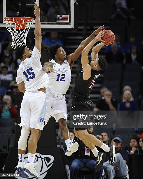 Jahlil Okafor and Justise Winslow of the Duke Blue Devils defend a shot by J.J. O'Brien of the San Diego State Aztecs during the third round of the...