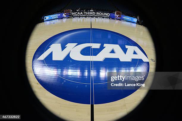 View of the NCAA logo at mid-court prior to a game between the Michigan State Spartans and the Virginia Cavaliers during the third round of the 2015...