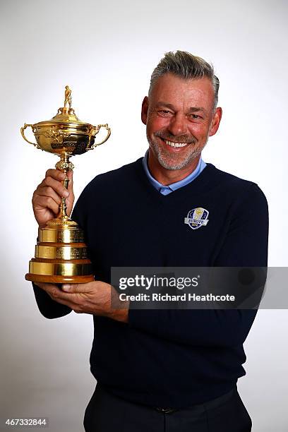 European Ryder Cup Captain Darren Clarke of Northern Ireland poses with the Ryder Cup trophy during a Ryder Cup Photocall at the Sofitel hotel on...