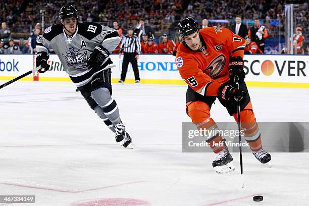 Ryan Getzlaf of the Anaheim Ducks moves the puck against Anze Kopitar of the Los Angeles Kings during the 2014 Coors Light NHL Stadium Series at...