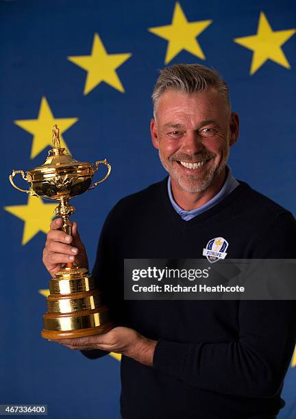 European Ryder Cup Captain Darren Clarke of Northern Ireland poses with the Ryder Cup trophy during a Ryder Cup Photocall at the Sofitel hotel on...