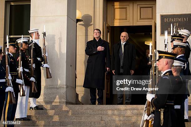 From left, U.S. Defense Secretary Ash Carter welcomes Afghan President Ashraf Ghani as they listen to the national anthem from both countries during...