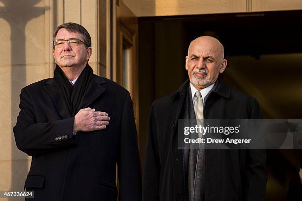 From left, U.S. Defense Secretary Ash Carter welcomes Afghan President Ashraf Ghani as they listen to the national anthem from both countries during...