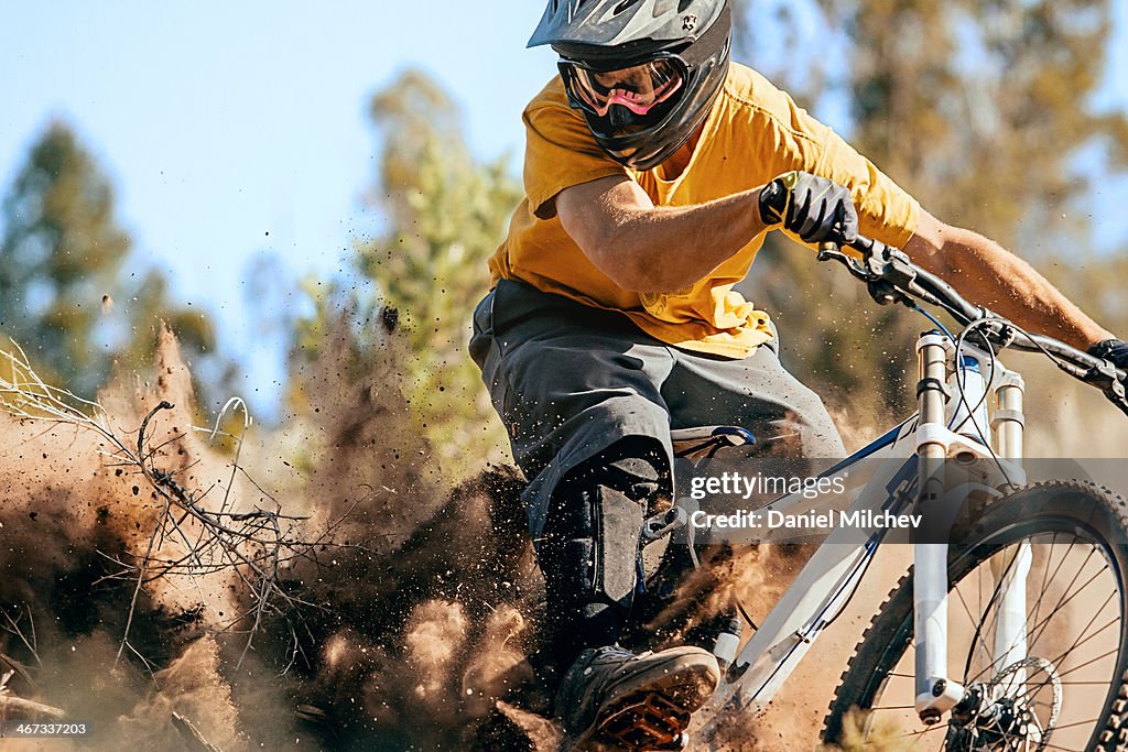 Close up of a mountain biker ripping through dirt.