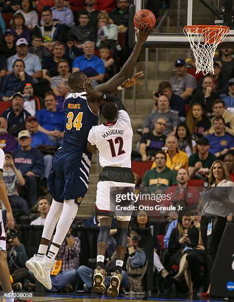 Mamadou Ndiaye of the UC Irvine Anteaters in action against Mangok Mathiang of the Louisville Cardinals during the second round of the 2015 Men's...