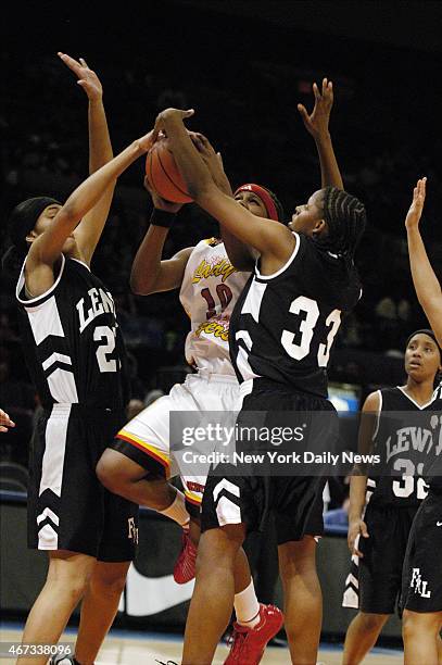 Murrry Bergtraum's Epiphanny Prince tries to score vs. Francis Lewis' Trenise Fuller and Dawn Coleman during the first half of their PSAL...