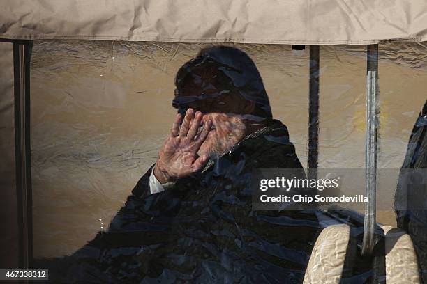 Fghanistan Chief Executive Abdullah Abdullah waves to memebers of the press from inside a covered golf cart after he and Afghanistan President Ashraf...