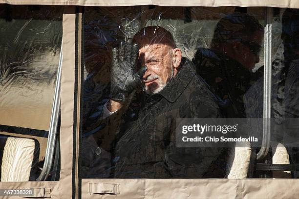 Afghanistan President Ashraf Ghani waves to members of the press from inside a covered golf cart after he and Afghanistan Chief Executive Abdullah...