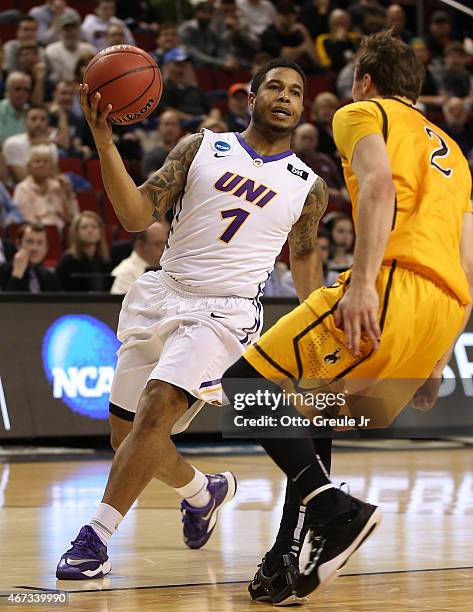 Deon Mitchell of the UNI Panthers drives against Riley Grabau of the Wyoming Cowboys during the second round of the 2015 Men's NCAA Basketball...