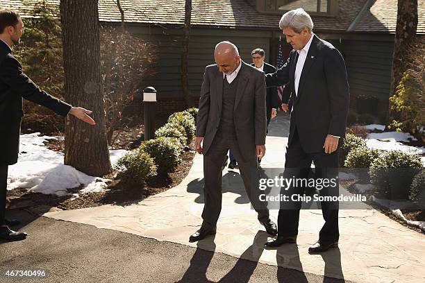 Afghanistan President Ashraf Ghani and U.S. Secretary of State John Kerry walk out to make brief remarks before sitting down for talks at Camp David...