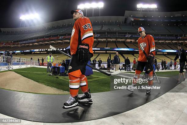 Mark Fistric and Bryan Allen of the Anaheim Ducks walk onto the field prior to team practice in preparation for the 2014 Coors Light NHL Stadium...