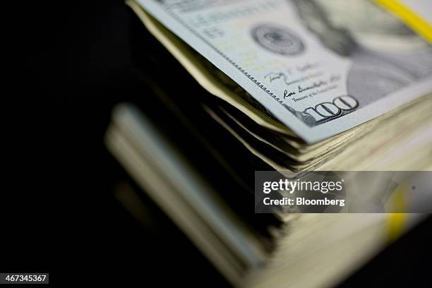 Bill sits on a stack of currency in this arranged photograph in Washington, D.C., U.S., on Thursday, Feb. 6, 2014. A suspension of the federal debt...