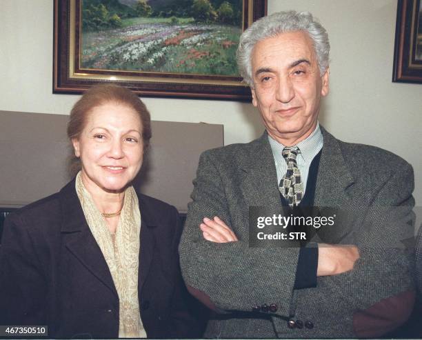 Hocine Ait Ahmed, leader of Algeria 's Socialist Forces Front stands with his wife Djamila at Algiers airport ' VIP lounge 02 February after three...