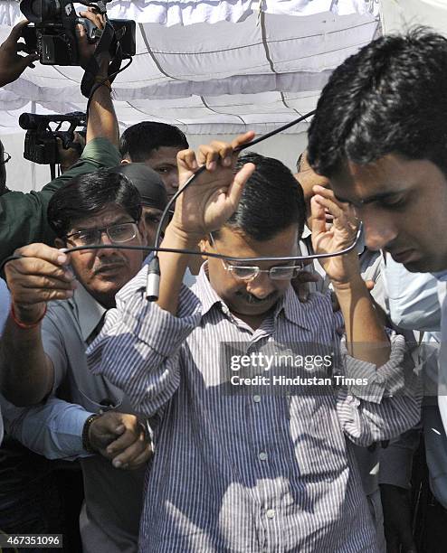 Delhi Chief Minister Arvind Kejriwal got entangled with the camera wires while addressing the media persons during paying tribute to mark the...