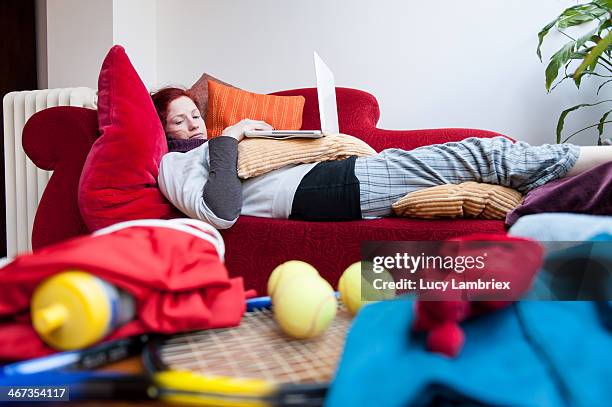 gym bunny or couch potato? - couch potato stockfoto's en -beelden