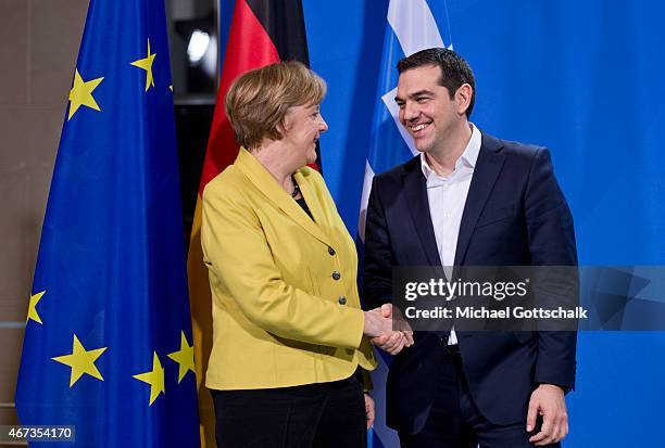 Greek Prime Minister Alexis Tsipras and German Chancellor Angela Merkel attend a press conference following talks at the German Chancellery on March...