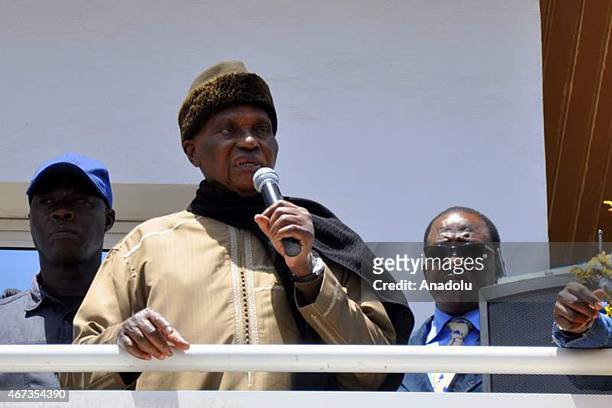 Former Senegal president Abdoulaye Wade speaks to crowd as people gather to support Karim Wade who is sentence to six years in prison, in front of...
